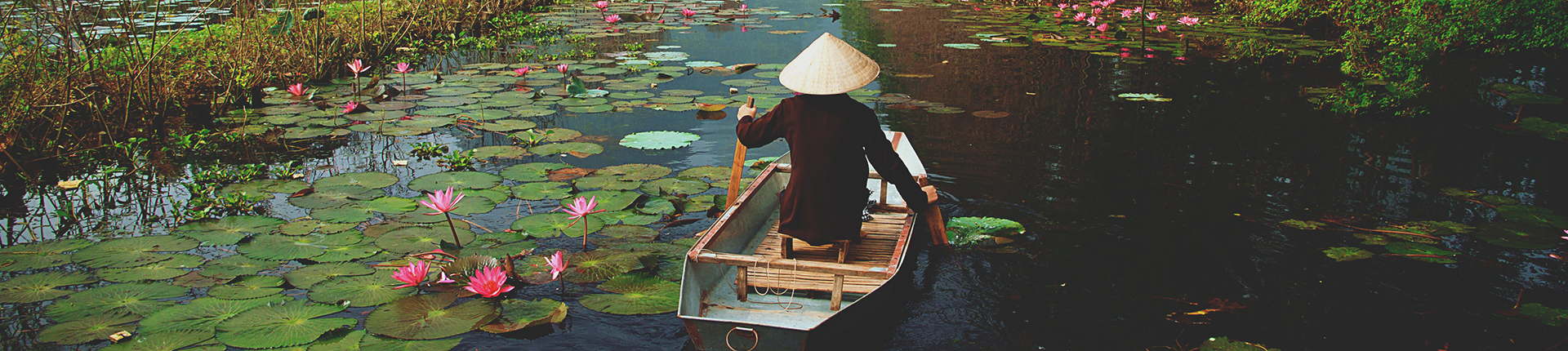 Person in a sampan boat on Yen stream in Hanoi, Vietnam